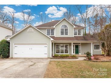 Charming two-story home with manicured lawn and two-car garage at 17521 Cambridge Grove Dr, Huntersville, NC 28078