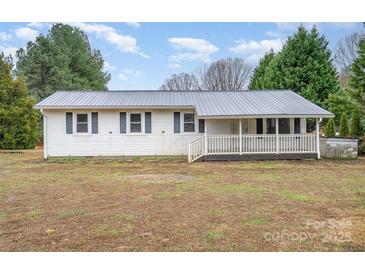 Charming single-story home with a metal roof and inviting front porch at 1876 Rollins Dr, Catawba, NC 28609