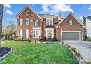 Brick two-story house with a landscaped lawn and attached garage at 19906 Catamaran Ct, Cornelius, NC 28031