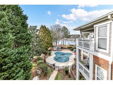 Community pool with lake views and surrounding deck at 7844 Village Harbor Dr # 36, Cornelius, NC 28031