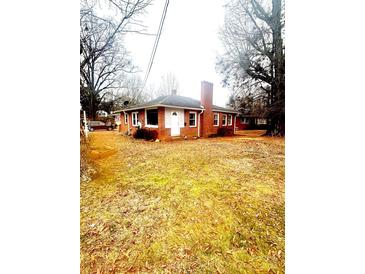 Brick ranch house with a large front yard and mature trees at 901 Maple Ave, Salisbury, NC 28144