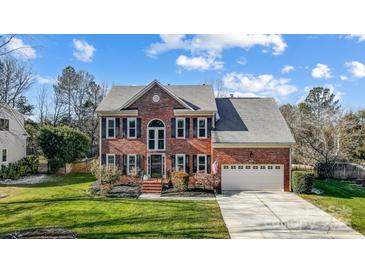 Brick two-story house with a large yard and attached garage at 9236 Silver Pine Dr, Charlotte, NC 28277