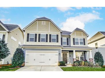 Two-story home with gray and beige siding, two-car garage, and landscaped yard at 1026 Slew O Gold Ln, Indian Trail, NC 28079