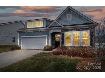 Gray exterior house with stone accents, two-car garage, and landscaping at 131 E Northstone Rd, Mooresville, NC 28115