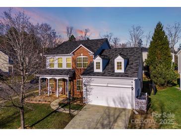 Brick two-story house with attached garage and landscaped yard at 2003 Galty Ln, Charlotte, NC 28270