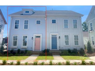 Charming exterior of two-story home with light blue paint, complemented by a well-manicured lawn at 266 Gilead Rd, Huntersville, NC 28078