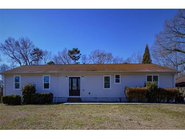 Charming single-story home with a well-maintained lawn and mature landscaping at 6615 Love Mill Rd, Monroe, NC 28110