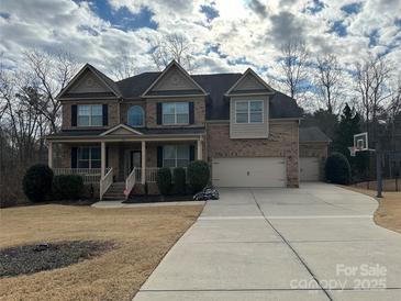 Two-story brick home with a three-car garage and landscaped yard at 829 Palmetto Bay Dr, Fort Mill, SC 29715