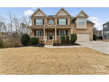 Charming two-story brick home with a welcoming front porch and well-manicured lawn at 829 Palmetto Bay Dr, Fort Mill, SC 29715