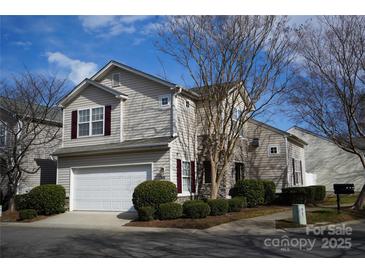 Two-story house with attached garage and landscaping at 9445 Meadowmont View Dr # 137, Charlotte, NC 28269