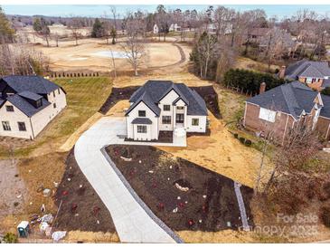 Stunning new construction featuring a long driveway and a beautifully landscaped front yard at 963 North Shore Dr, Hickory, NC 28601