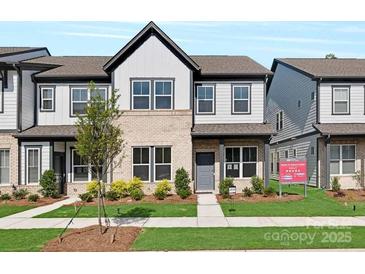 Charming new two-story townhome with landscaped front yard, brick accents, and inviting entrance at 3116 Beacon Heights Rd, Indian Land, SC 29707