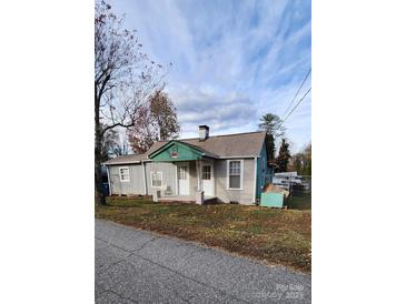 Charming single-story house with a teal exterior, covered porch, and spacious yard at 3706 2Nd Nw Ave, Hickory, NC 28601