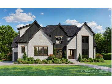 Beautiful two-story home featuring a brick facade, dark-framed windows, and a professionally landscaped front yard at 612 Deodar Cedar Dr, Weddington, NC 28104