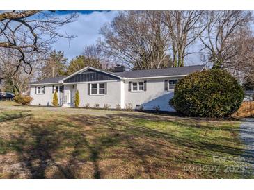 Charming single-story home with painted brick, black shutters, and mature landscaping at 6305 Dale Ave, Charlotte, NC 28212