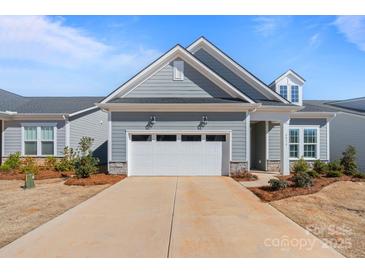 Charming home featuring an attached two-car garage and stone accents at 8016 Brookbank Dr, Charlotte, NC 28269