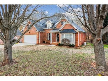 Charming brick home featuring an attached two-car garage and manicured front lawn at 2608 Golden Bell Dr, Gastonia, NC 28056