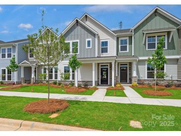 Charming new townhomes with stone accents, well-manicured lawns, and inviting front porches at 10117 Mamillion Dr, Huntersville, NC 28078