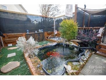 Koi pond with surrounding landscaping and lighting at 1825 Bloomsbury Dr, Rock Hill, SC 29730