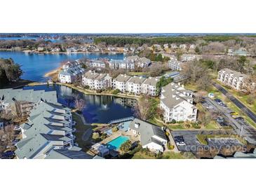 Stunning aerial view of waterfront condos featuring a swimming pool, fountain, and lake access at 18736 Nautical Dr # 201, Cornelius, NC 28031