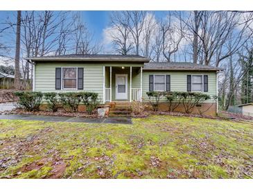 Ranch home with green siding, brick base, and landscaping at 4452 Huntington Dr, Gastonia, NC 28056