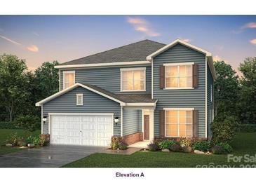 Charming two-story home featuring light blue siding, a two-car garage, and beautifully landscaped front yard at 4796 North Wynswept Dr, Maiden, NC 28650