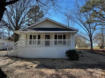 Charming white home with inviting front porch and a well-maintained lawn at 520 Waddell Dr, Albemarle, NC 28001