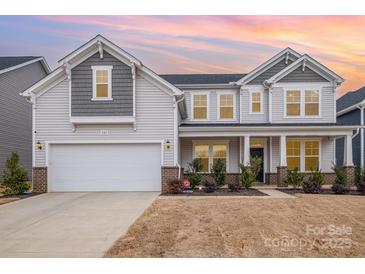 Two-story home with gray siding, brick accents, and a two-car garage at 545 Shallowford Dr, Rock Hill, SC 29732