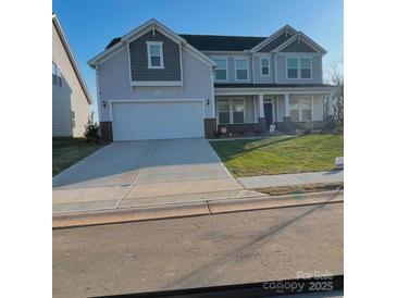 Two-story house with gray siding, brick accents, and a two-car garage at 545 Shallowford Dr, Rock Hill, SC 29732