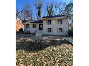 Newly renovated brick house with shutters, front steps, and a grassy yard at 5531 Londonderry Rd, Charlotte, NC 28210