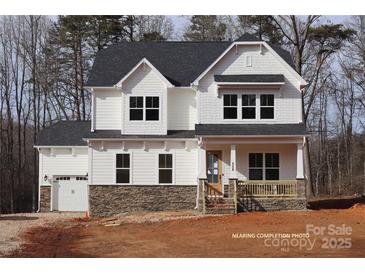 Two-story home with white siding, stone accents, and a two-car garage at 558 Edmunds Ln # 41, Clover, SC 29710