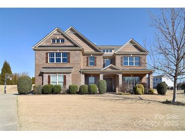 Brick two-story home with landscaped yard and driveway at 5600 Ballenger Ct, Waxhaw, NC 28173