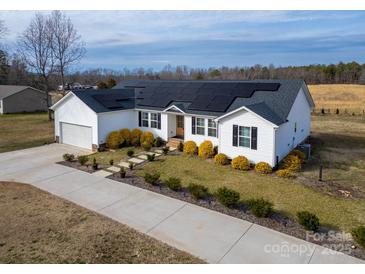 Beautiful one-story home featuring solar panels, a well-manicured lawn, and a long driveway at 9489 Westridge Dr, Hickory, NC 28601