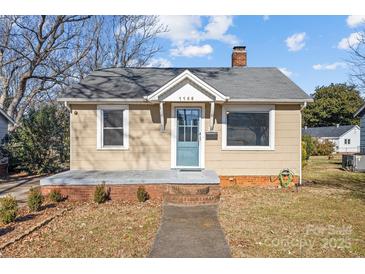 Charming home featuring a light beige exterior, blue front door, and brick foundation at 1155 Eden Ter, Rock Hill, SC 29730