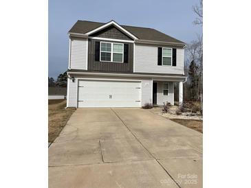 Two-story house with a white and gray exterior, a double garage, and landscaping at 155 Trail Wood Ct, Salisbury, NC 28146