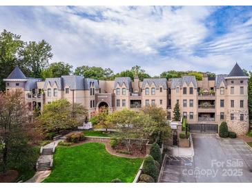 Luxury condo building with manicured landscaping and parking at 3238 Park Rd, Charlotte, NC 28209