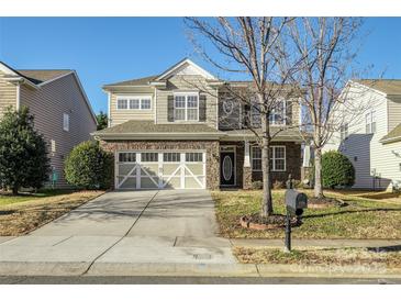 Two-story house with stone accents, two-car garage, and landscaping at 5726 Cactus Valley Rd # 238, Charlotte, NC 28277