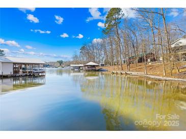 Calm lake with waterfront homes and beautiful reflections at 126 Abbey Ln, Mount Gilead, NC 27306