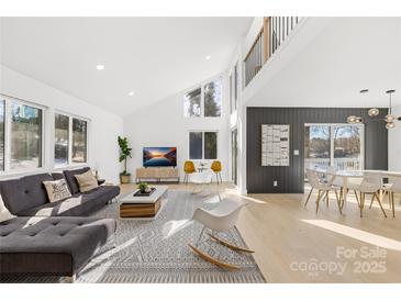 Bright living room featuring hardwood floors and large windows at 126 Abbey Ln, Mount Gilead, NC 27306