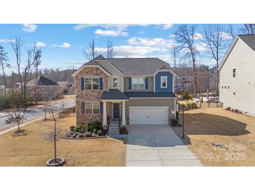 Two-story house with gray siding, brick accents, and a two-car garage at 13303 Hyperion Hills Ln, Charlotte, NC 28278