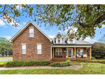 Brick ranch home with front porch and landscaping at 214 Heather Glen Ln, Belmont, NC 28012