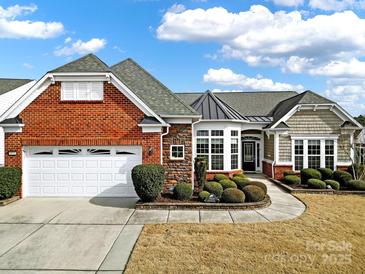 Brick and stone ranch home with attached garage and landscaped yard at 3024 Ambleside Dr, Fort Mill, SC 29707