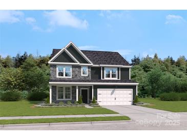 Two-story house with gray siding, stone accents, and a two-car garage at 312 Coronado Ave # 41, Matthews, NC 28104