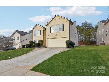 Two-story house with a beige exterior, two-car garage, and well-manicured lawn at 3366 Table Rock Dr, Gastonia, NC 28052