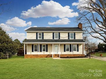 Charming two-story home featuring a welcoming front porch and well-manicured lawn at 509 Baucom Deese Rd, Monroe, NC 28110