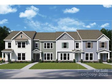 Three-unit townhome building with modern design and landscaping at 10123 Mamillion Dr, Huntersville, NC 28078
