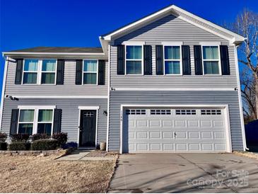 Two-story house with gray siding, black shutters, and a two-car garage at 1148 Tangle Ridge Se Dr, Concord, NC 28025