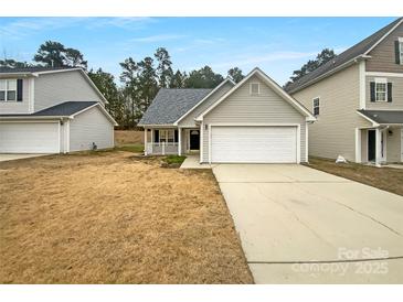 Beige two-story house with attached garage and small front yard at 1791 Mission Oaks St, Kannapolis, NC 28083