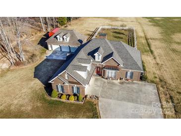 Expansive aerial view of brick home, detached garage, long driveway, and large yard at 219 Society Rd, Statesville, NC 28625