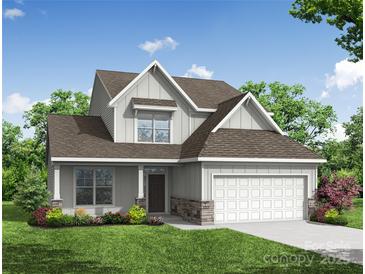 Charming two-story home featuring a gray exterior, well-manicured lawn, and an attached two-car garage at 5108 Verona Rd # 94, Charlotte, NC 28213